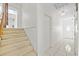 Carpeted staircase with white walls and access to an upstairs landing at 17025 Dolphin Dr, North Redington Beach, FL 33708