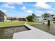 Waterfront home with a dock, pool and nice green lawn in the backyard at 17025 Dolphin Dr, North Redington Beach, FL 33708