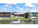 Waterfront backyard with a dock, green lawn and a private pool at 17025 Dolphin Dr, North Redington Beach, FL 33708