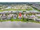 Aerial view of the home, situated on a lake, surrounded by mature trees at 1830 Cameron Ct, Trinity, FL 34655