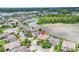 Aerial view of house close to a pond showing off its lush green surroundings at 1830 Cameron Ct, Trinity, FL 34655