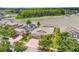 Aerial view of home near a lake, landscaping, and brick driveway at 1830 Cameron Ct, Trinity, FL 34655