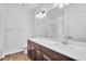 Bathroom featuring a large mirror, vanity with dark wood cabinets, and a shower-tub combo at 1830 Cameron Ct, Trinity, FL 34655
