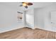 Bright bedroom with a window, closet, ceiling fan, and wood-look floors at 1830 Cameron Ct, Trinity, FL 34655