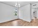 Empty bedroom featuring wood floors, large window, closet and modern chandelier at 1830 Cameron Ct, Trinity, FL 34655