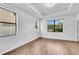 Bright bedroom with hardwood floors and tray ceilings with big windows bringing the outside in at 1830 Cameron Ct, Trinity, FL 34655