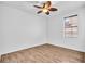 A bright, airy bedroom with hardwood floors, a ceiling fan, and a window with blinds at 1830 Cameron Ct, Trinity, FL 34655