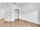Empty bedroom with wood floors, closet, and a doorway leading to another room at 1830 Cameron Ct, Trinity, FL 34655
