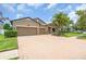 Charming home features a brick driveway, a two-car garage, and stone accents on the facade at 1830 Cameron Ct, Trinity, FL 34655