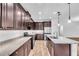 Kitchen with stainless steel appliances, an island with a sink, and dark wood cabinets at 1830 Cameron Ct, Trinity, FL 34655