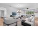 Spacious living room with modern furnishings, including white sofas, a flat-screen TV, and stylish decor at 1830 Cameron Ct, Trinity, FL 34655