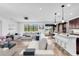 Open-concept living room featuring a modern kitchen, bright dining area, and comfortable seating arrangement at 1830 Cameron Ct, Trinity, FL 34655
