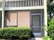 Close up of the condo doorway with screened door at 1865 Mazo Manor # 1, Lutz, FL 33558