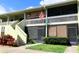 Charming condo exterior with private screened porch and well maintained landscaping at 1865 Mazo Manor # 1, Lutz, FL 33558