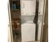 In unit laundry area with shelving for storage at 1865 Mazo Manor # 1, Lutz, FL 33558