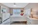 Comfortable bedroom with a large bed, a window view and white dressers provides a peaceful retreat at 19029 Us Highway 19 N # 8-31, Clearwater, FL 33764