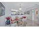 Bright dining area featuring a glass table and views into the adjacent kitchen at 19029 Us Highway 19 N # 8-31, Clearwater, FL 33764