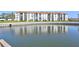 Waterfront condo building with orange tile roof reflected in the water at 19029 Us Highway 19 N # 8-31, Clearwater, FL 33764