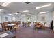 Brightly lit game room featuring multiple tables and chairs with serene views of the outdoors at 19029 Us Highway 19 N # 8-31, Clearwater, FL 33764