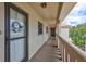 Exterior hallway leading to front door with decorative wreath and natural light at 19029 Us Highway 19 N # 8-31, Clearwater, FL 33764