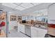 Well-lit kitchen with white cabinets, breakfast bar, and stainless steel dishwasher at 19029 Us Highway 19 N # 8-31, Clearwater, FL 33764