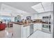 Open kitchen area with stainless steel appliances and breakfast bar overlooking the living area at 19029 Us Highway 19 N # 8-31, Clearwater, FL 33764