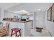 Kitchen and bar area with stainless steel appliances, white cabinetry and tile floors at 19029 Us Highway 19 N # 8-31, Clearwater, FL 33764