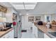 Kitchen area with stainless steel refrigerator and tiled floors at 19029 Us Highway 19 N # 8-31, Clearwater, FL 33764