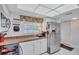 Bright kitchen with white cabinets, stainless steel refrigerator, and tiled countertops at 19029 Us Highway 19 N # 8-31, Clearwater, FL 33764
