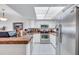 Bright kitchen featuring white cabinetry, stainless steel appliances, and terracotta countertops at 19029 Us Highway 19 N # 8-31, Clearwater, FL 33764