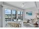 Bright sunroom with water views, tile flooring and comfortable seating is perfect for enjoying morning coffee at 19029 Us Highway 19 N # 8-31, Clearwater, FL 33764