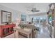 Open living room with access to balcony, tile floors, and comfortable seating at 19029 Us Highway 19 N # 8-31, Clearwater, FL 33764