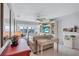 Bright living room with large windows and views, featuring a TV and comfortable furnishings at 19029 Us Highway 19 N # 8-31, Clearwater, FL 33764