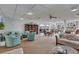 Inviting lounge area with cozy seating, bookshelves, and access to outdoor amenities by the water at 19029 Us Highway 19 N # 8-31, Clearwater, FL 33764