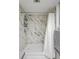 Updated stand-up shower featuring modern fixtures and a beautiful marble surround at 19029 Us Highway 19 N # 8-31, Clearwater, FL 33764