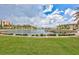 Scenic water view surrounded by well-maintained grounds and community buildings under a cloudy sky at 19029 Us Highway 19 N # 8-31, Clearwater, FL 33764
