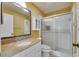 Bathroom with granite countertop vanity and a tiled glass door shower at 1903 Canterbury Ln # B24, Sun City Center, FL 33573