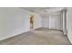 Bright bedroom featuring plush carpeting, neutral decor, and double closets at 1903 Canterbury Ln # B24, Sun City Center, FL 33573