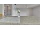 Kitchen island with cooktop and a view of the adjacent room and backyard at 1903 Canterbury Ln # B24, Sun City Center, FL 33573