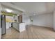 Open kitchen with white cabinets, stainless steel appliances, and a breakfast bar at 1903 Canterbury Ln # B24, Sun City Center, FL 33573