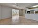 Open concept living room with tile flooring, a ceiling fan, and a view into the sunroom at 1903 Canterbury Ln # B24, Sun City Center, FL 33573
