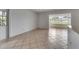 Bright living area with large windows, neutral paint, and tile flooring at 1903 Canterbury Ln # B24, Sun City Center, FL 33573