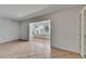 Bright, open-concept living room features tile flooring and large opening to an adjacent sun room at 1903 Canterbury Ln # B24, Sun City Center, FL 33573