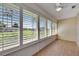 Sun room with tile flooring, ceiling fan, and plantation shutters overlooking the backyard at 1903 Canterbury Ln # B24, Sun City Center, FL 33573