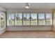 Bright sunroom featuring shuttered windows overlooking the green lawn at 1903 Canterbury Ln # B24, Sun City Center, FL 33573