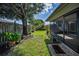 The spacious backyard showcases a screened lanai and lush landscaping with privacy fencing at 2559 Redwood Cir, Clearwater, FL 33763