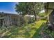 Lush backyard with mature trees, privacy fence, and brick-lined garden beds, perfect for gardening at 2559 Redwood Cir, Clearwater, FL 33763