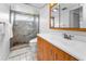 Bathroom featuring a white countertop sink, wood drawers, and glass shower at 2559 Redwood Cir, Clearwater, FL 33763