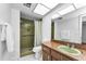 Cozy bathroom featuring an updated vanity, walk-in shower, and neutral color palette at 2559 Redwood Cir, Clearwater, FL 33763