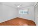 Bedroom featuring wood floors, bright natural light from one window, and a ceiling fan at 2559 Redwood Cir, Clearwater, FL 33763